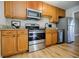 Functional kitchen featuring wood cabinets, granite countertops, and stainless steel appliances at 3312 Northcrest Rd # A, Atlanta, GA 30340