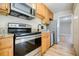 Bright kitchen with wood cabinets, stainless steel appliances, and granite counters at 3312 Northcrest Rd # A, Atlanta, GA 30340