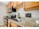 This is a well-lit kitchen with a stone countertop, stainless steel sink, microwave, and oven at 3312 Northcrest Rd # A, Atlanta, GA 30340