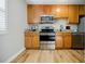 Well-lit kitchen featuring wood cabinets, granite countertops, and stainless steel appliances at 3312 Northcrest Rd # A, Atlanta, GA 30340