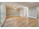 Expansive living room boasting hardwood floors, neutral walls, a ceiling fan, and French doors to a private outdoor area at 3312 Northcrest Rd # A, Atlanta, GA 30340