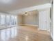 Bright living room with hardwood floors, ceiling fan, and a set of French doors leading to a fenced in outdoor space at 3312 Northcrest Rd # A, Atlanta, GA 30340
