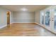 Sunlit living room with hardwood floors, neutral walls, access to the kitchen, and French doors leading to an outdoor area at 3312 Northcrest Rd # A, Atlanta, GA 30340