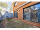 Private back patio features sliding glass doors, brick accents, with ample space for outdoor seating and relaxation at 3318 Northcrest Rd # D, Atlanta, GA 30340