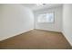 Well-lit bedroom with neutral carpet, white walls, and bright window at 3318 Northcrest Rd # D, Atlanta, GA 30340