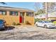 Charming brick condo featuring a vibrant red door and convenient parking spaces for residents and guests at 3318 Northcrest Rd # D, Atlanta, GA 30340