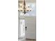 Inviting foyer showcases an elegant chandelier, white paneled door, and decorative glass providing a warm welcome at 3318 Northcrest Rd # D, Atlanta, GA 30340