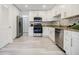 Bright kitchen features white cabinets, stainless steel appliances, and granite countertops at 3318 Northcrest Rd # D, Atlanta, GA 30340
