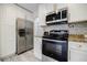 Bright kitchen features stainless steel appliances, white cabinets, and granite countertops at 3318 Northcrest Rd # D, Atlanta, GA 30340