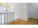 Stairway landing with chandelier and hardwood floors at 3318 Northcrest Rd # D, Atlanta, GA 30340