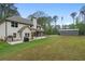 Expansive backyard with a lush green lawn, screened porch, patio and large steel building at 337 Paynes Lake Rd, Carrollton, GA 30116