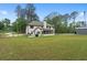 Spacious backyard featuring a patio, lush green lawn and large steel building at 337 Paynes Lake Rd, Carrollton, GA 30116