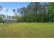 Large backyard featuring a metal shed and fenced in area perfect for pets or play at 337 Paynes Lake Rd, Carrollton, GA 30116