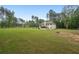Expansive backyard with a two-story home, surrounded by lush trees and a well-maintained lawn at 337 Paynes Lake Rd, Carrollton, GA 30116