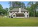 Large backyard featuring a covered, screened porch, patio and lush green lawn at 337 Paynes Lake Rd, Carrollton, GA 30116