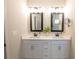 Bright bathroom vanity features double sinks, neutral countertops and framed mirrors with modern lighting at 337 Paynes Lake Rd, Carrollton, GA 30116