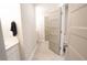 Neutral bathroom featuring tile floors, light fixtures, and grey doors for added privacy and style at 337 Paynes Lake Rd, Carrollton, GA 30116