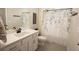 Bright bathroom features a vanity with a white countertop, a shower with an attractive shower curtain and gray floors at 337 Paynes Lake Rd, Carrollton, GA 30116