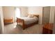 Bright bedroom features a wooden sleigh bed, neutral walls, and plush carpeting at 337 Paynes Lake Rd, Carrollton, GA 30116