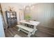 Dining room features a wooden table with white trim, wooden floors, chandelier, and modern farmhouse aesthetic at 337 Paynes Lake Rd, Carrollton, GA 30116