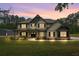 Charming two-story home with a beautifully landscaped yard, porch, and sunset sky at 337 Paynes Lake Rd, Carrollton, GA 30116