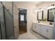 Main bathroom features double sink vanity with marble floors, and a doorway to the spacious main bedroom at 337 Paynes Lake Rd, Carrollton, GA 30116