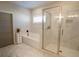 Spa-like bathroom with soaking tub, glass enclosed shower, and marble floors for a luxurious feel at 337 Paynes Lake Rd, Carrollton, GA 30116