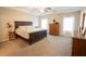 Spacious main bedroom features a tray ceiling, neutral carpeting and decor, and natural light from windows at 337 Paynes Lake Rd, Carrollton, GA 30116