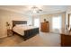 Spacious main bedroom features a tray ceiling, neutral carpeting and decor, and natural light from windows at 337 Paynes Lake Rd, Carrollton, GA 30116