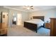 Relaxing main bedroom boasts plush carpet, a decorative ceiling fan, and a spa-like ensuite bathroom at 337 Paynes Lake Rd, Carrollton, GA 30116