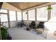 Relaxing screened-in porch features a ceiling fan, neutral colors, and comfortable seating for enjoying the outdoors at 337 Paynes Lake Rd, Carrollton, GA 30116