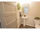 Charming powder room featuring a pedestal sink and stylish decor, perfect for guests' convenience at 337 Paynes Lake Rd, Carrollton, GA 30116