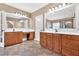 Bathroom featuring tile flooring, wooden cabinets and double sinks beneath well-lit mirrors at 17 River Walk Pkwy, Euharlee, GA 30145