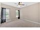 Bedroom featuring carpet and two windows with dark curtains at 17 River Walk Pkwy, Euharlee, GA 30145