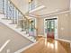Bright foyer featuring hardwood floors, a staircase with wrought iron accents, and a welcoming entryway at 17 River Walk Pkwy, Euharlee, GA 30145