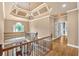 Elegant foyer area with hardwood floors, iron rod stair railing and decorative ceiling at 17 River Walk Pkwy, Euharlee, GA 30145