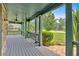 Spacious covered porch showcasing beautiful columns, a peaceful view, and well-maintained landscaping at 17 River Walk Pkwy, Euharlee, GA 30145