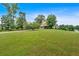 Large grassy front yard leading to home with an attached two-car garage at 17 River Walk Pkwy, Euharlee, GA 30145