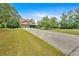 Expansive front yard with a long driveway leading to a beautiful, well-maintained home at 17 River Walk Pkwy, Euharlee, GA 30145