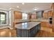 Spacious kitchen featuring a large island with granite countertops and custom cabinets at 17 River Walk Pkwy, Euharlee, GA 30145