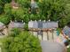 Overhead view of brick townhomes with mature trees and private driveways in a well-kept community at 2779 Bentley Se Pl, Marietta, GA 30067