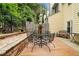 Outdoor deck area with iron table and chairs, surrounded by mature trees and landscaping at 2779 Bentley Se Pl, Marietta, GA 30067