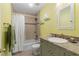 Yellow bathroom featuring a shower-tub combo, granite counters and tile details at 2779 Bentley Se Pl, Marietta, GA 30067