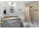 Bathroom showcasing a shower over tub, granite counters, stylish lighting and neutral tones at 2779 Bentley Se Pl, Marietta, GA 30067