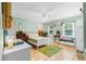 Bright bedroom with hardwood floors, neutral walls, and decorative plant accents at 2779 Bentley Se Pl, Marietta, GA 30067