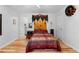 Inviting bedroom with hardwood floors, an eclectic starburst headboard and bright lighting at 2779 Bentley Se Pl, Marietta, GA 30067