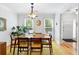 Charming dining room featuring wood floors, a light fixture and an area rug, perfect for meals and gatherings at 2779 Bentley Se Pl, Marietta, GA 30067