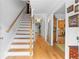 Inviting entryway featuring wood floors, a staircase with white risers and a wood railing and an open view at 2779 Bentley Se Pl, Marietta, GA 30067