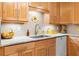 Bright kitchen featuring wood cabinets, granite countertops, stainless steel sink and modern appliances at 2779 Bentley Se Pl, Marietta, GA 30067