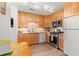 Bright kitchen featuring light wood cabinets, stainless steel appliances, and a dining table at 2779 Bentley Se Pl, Marietta, GA 30067